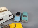 several toy cars are lined up on a gray surface