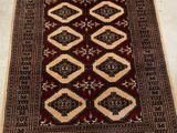 a brown and black rug with a diamond design on it