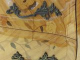 an image of a wooden chest of drawers with ornate handles