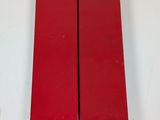 pair of red sleds on a white wall with a white background