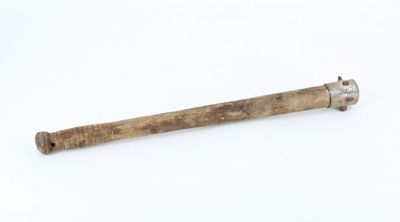 a wooden stick with a metal handle on a white surface