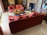 a living room with red couches and a fireplace