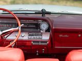 dashboard of a classic car with red leather seats and steering wheel