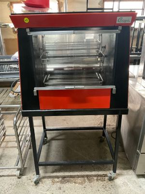 a red oven that is sitting in the middle of a kitchen