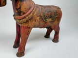 a small wooden horse with a saddle on it ' s back