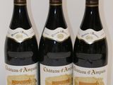 three bottles of wine are lined up on a table
