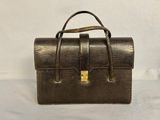 a brown leather purse with a gold clasp