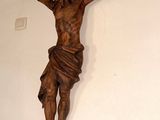 a statue of jesus hanging on the wall of a church