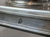 a close up of a silver plate on a table