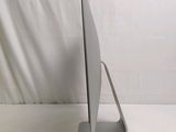 a computer monitor sitting on a stand on a white surface