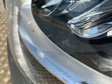 a close up of a car ' s headlight with a pair of scissors on it