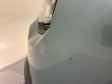 a close up of a car ' s front bumper with a hole in it