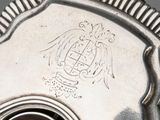 a close up of a silver plate with a clock on it