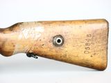 an old wooden rifle with a bullet on it ' s side