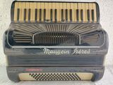 a very old accordion that is sitting on a table