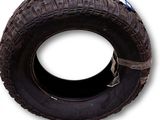 tire on a white background with a blue and white sticker on the tire