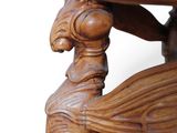 a close up of a wooden table with a bird on it