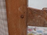 a close up of a wooden chair with a flowered seat