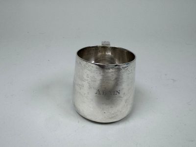 a silver cup that is sitting on a table