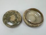 pair of green and brown pottery bowls on white surface