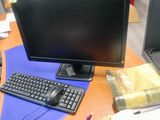 a computer monitor and keyboard on a desk