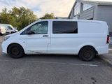 the white van is parked in the parking lot outside of the building