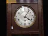 a clock that is on a shelf in a room