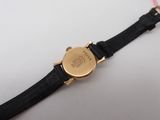 an image of a gold watch with a black leather strap