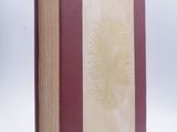 the book is red and white with a gold flower on the cover