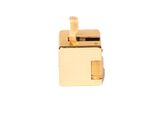 a small gold object on a white surface