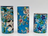 three vases that have been painted with flowers on them