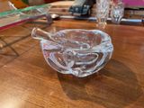 a glass bowl with a spoon in it on a table