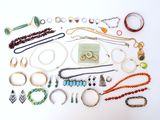 many different types of jewelry laid out on a white surface