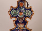 a blue cross with a bunch of flowers on it