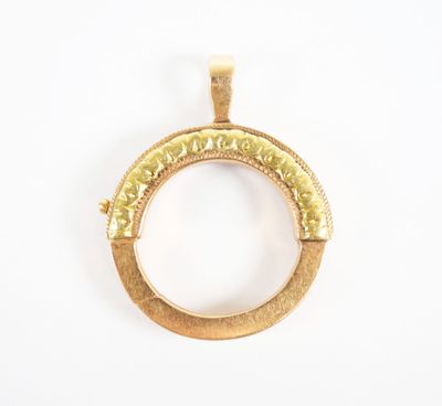 a close up of a gold ring pendant on a white background