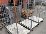 several metal cages with wheels are lined up in front of a building