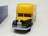 a yellow and black toy bus and a blue box