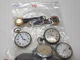 a bag of assorted pocket watches on a table