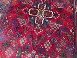 a red rug with a cross on it on the floor