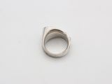 a close up of a silver ring on a white surface