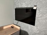 a flat screen tv mounted on a wall in a room