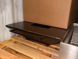 a box sitting on top of a wooden pallet next to a grill