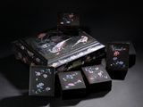 a black box with a design of birds and flowers on it