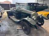 an old car that is sitting in a garage