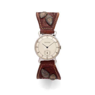 a close up of a wrist watch on a white surface
