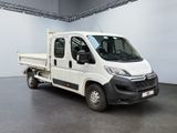 the small white truck is parked in a large room
