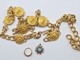 a close up of a chain with gold coins and a ring