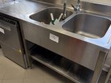 a stainless steel sink in the middle of a kitchen