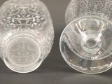 two empty glasses sitting next to each other on a table