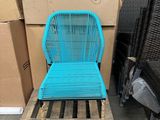 a blue chair sitting on a pallet next to a stack of boxes